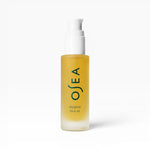 JONES + CO Dayglow Face Oil in a frosted glass bottle with a white pump. Seaweed-infused formula for a dewy finish.