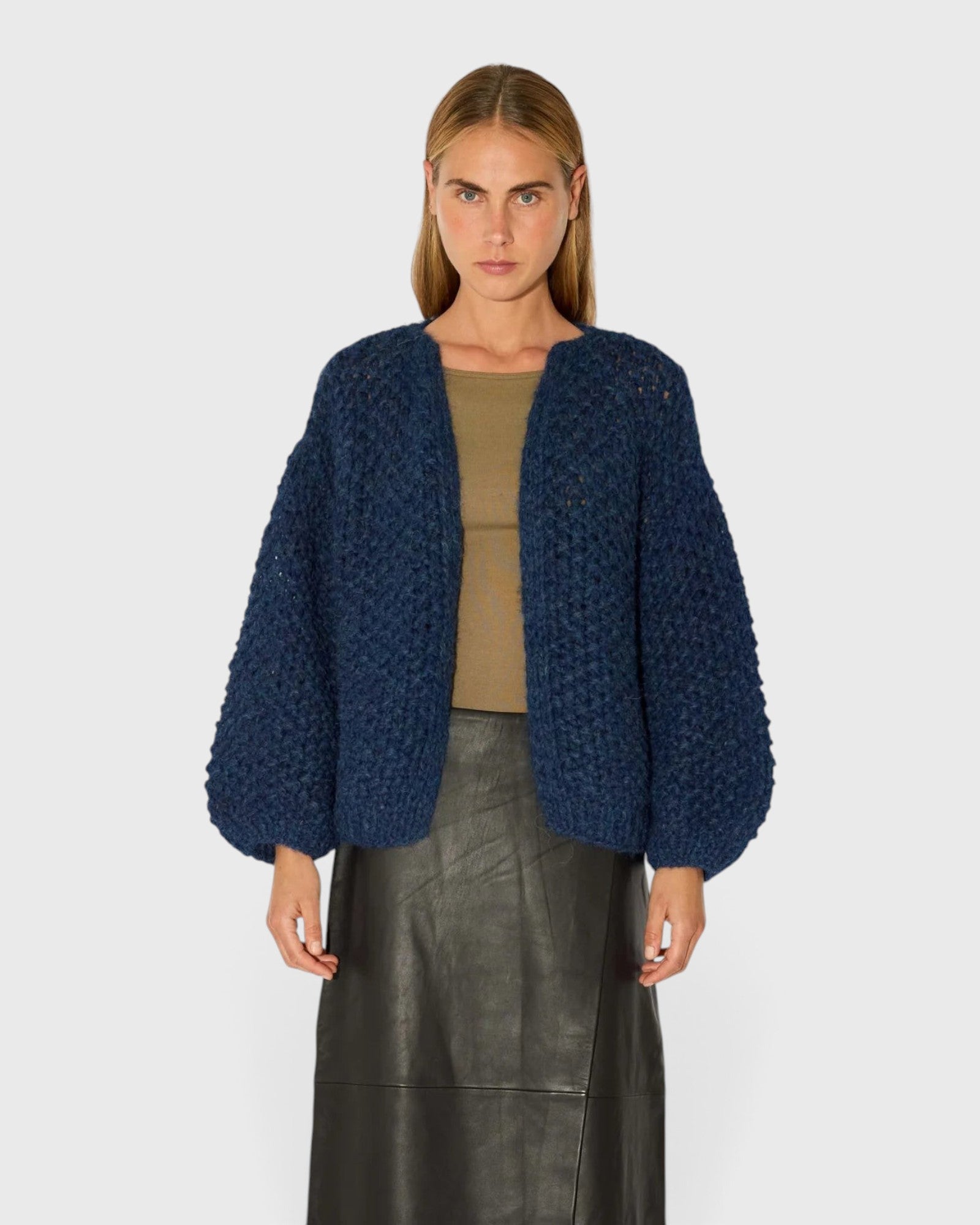 JONES + CO chunky denim blue alpaca bomber cardigan with a textured pearl knit pattern worn by a model.