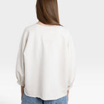 JONES + CO dirty white crewneck sweatshirt with drop shoulders, raw hem, and distressed detailing.