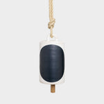 JONES + CO Thrown Bell in Domino Indigo featuring a white ceramic body with a large dark blue oval and rope hanger.