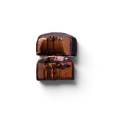 JONES + CO double chocolate truffle bar cut in half showing a smooth cacao centre with crunchy nibs and sea salt.