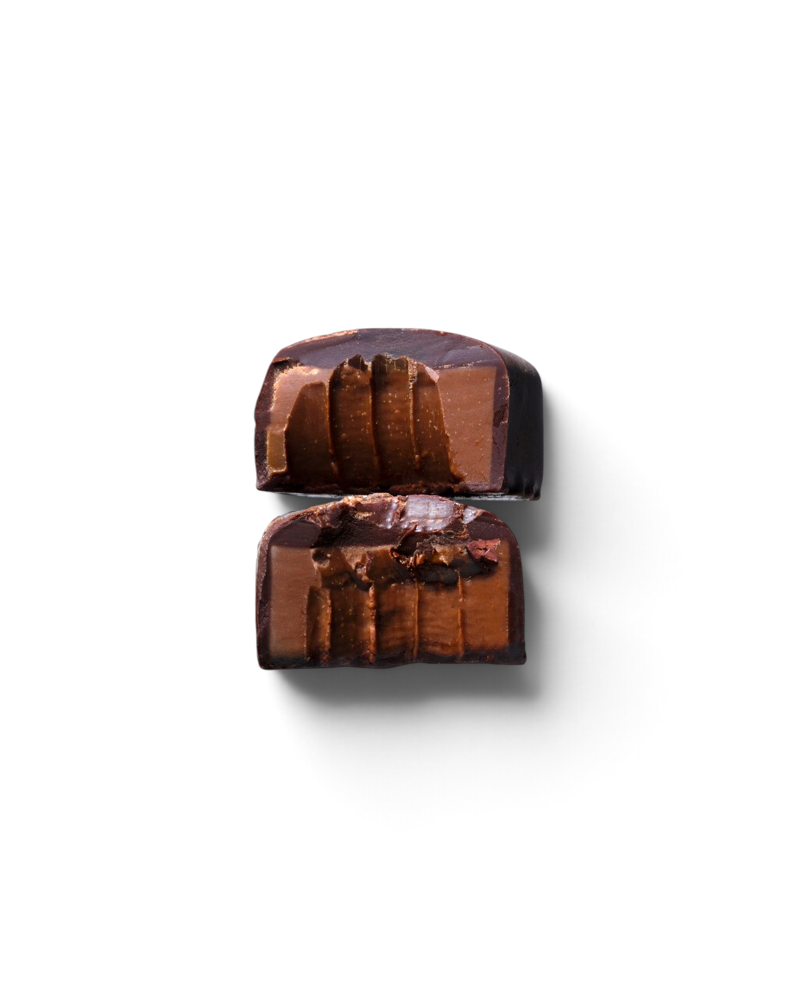 JONES + CO double chocolate truffle bar cut in half showing a smooth cacao centre with crunchy nibs and sea salt.