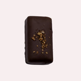 JONES + CO double chocolate truffle bar with a dark cacao shell, topped with crunchy cacao nibs and sea salt.