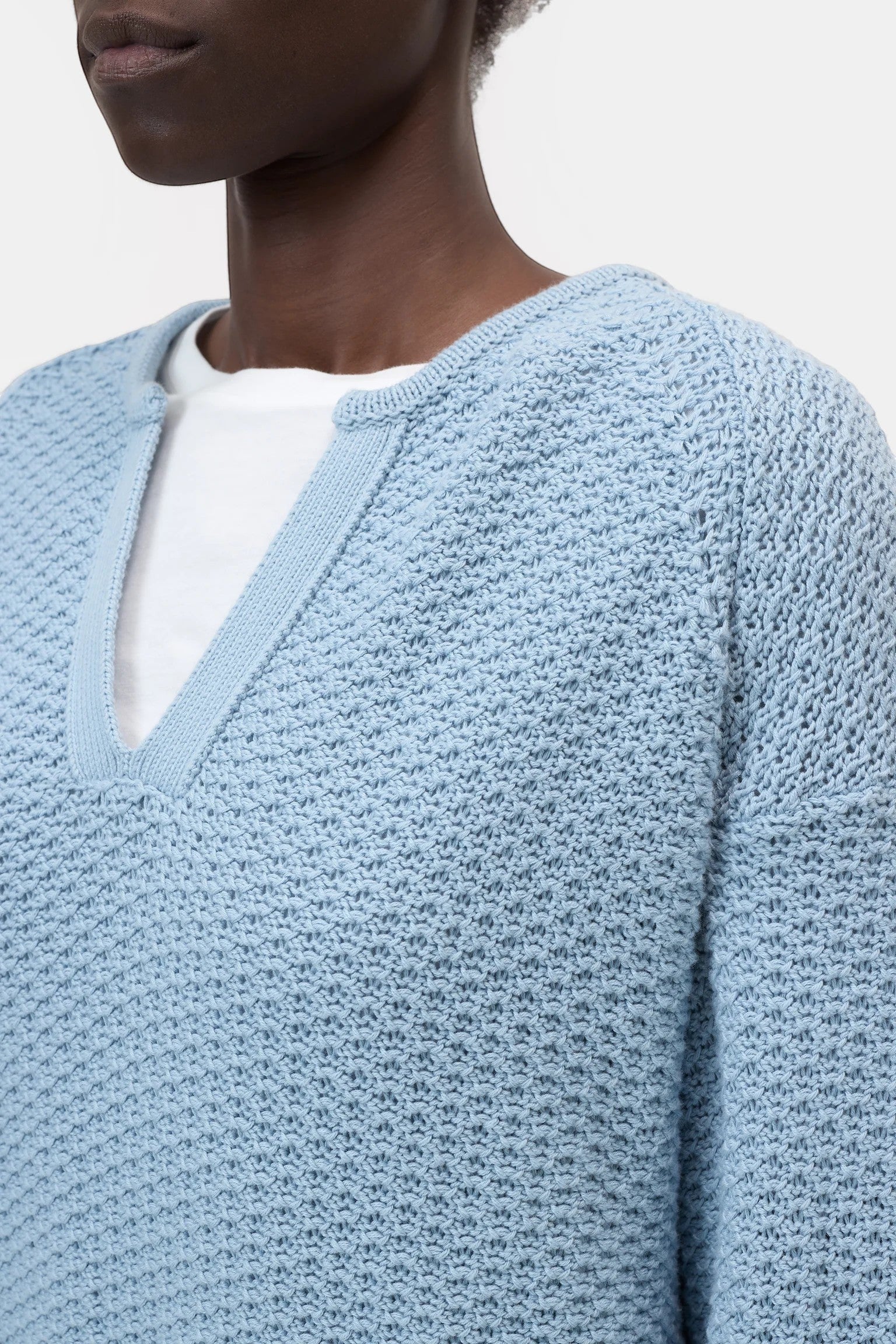 JONES + CO dove blue organic cotton knitted jersey with a 3D effect stripe pattern and V-neck.