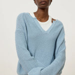 JONES + CO dove blue knitted jersey with 3D effect stitch and V-neck, made from organic cotton.