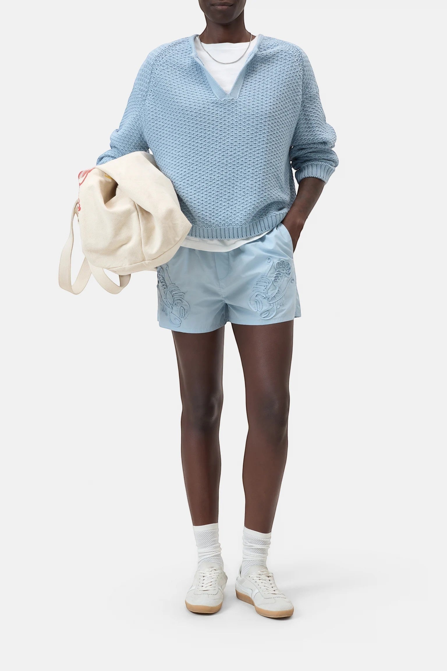 JONES + CO dove blue knitted jersey with 3D effect stripes, V-neck, and ribbed cuffs. Organic cotton.