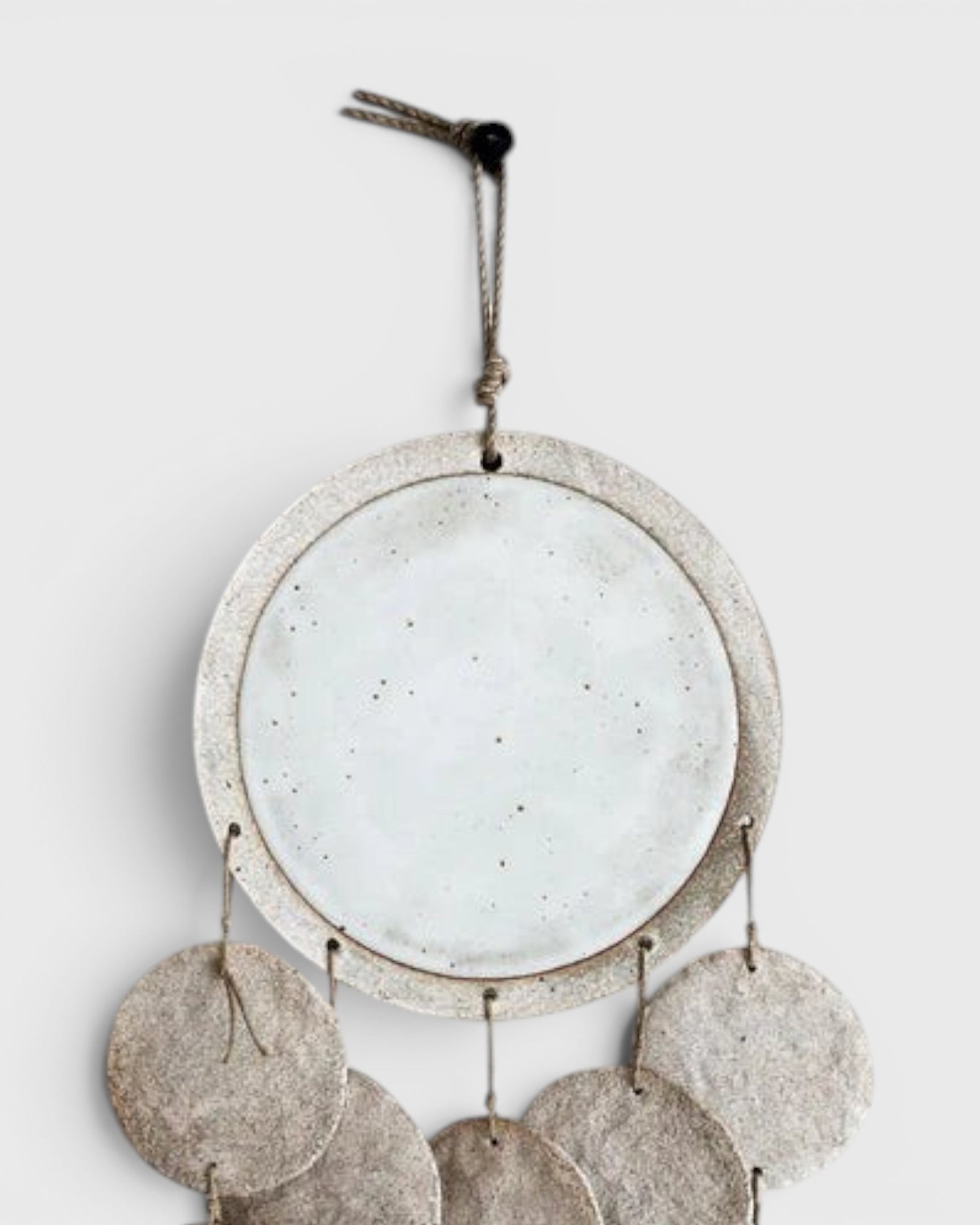 JONES + CO Dreamweaver wall hanging in Full Moon White featuring stoneware, porcelain, and natural hemp rope details.