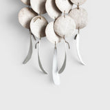 JONES + CO Dreamweaver wall hanging in Full Moon White featuring glazed stoneware discs and hemp rope accents.