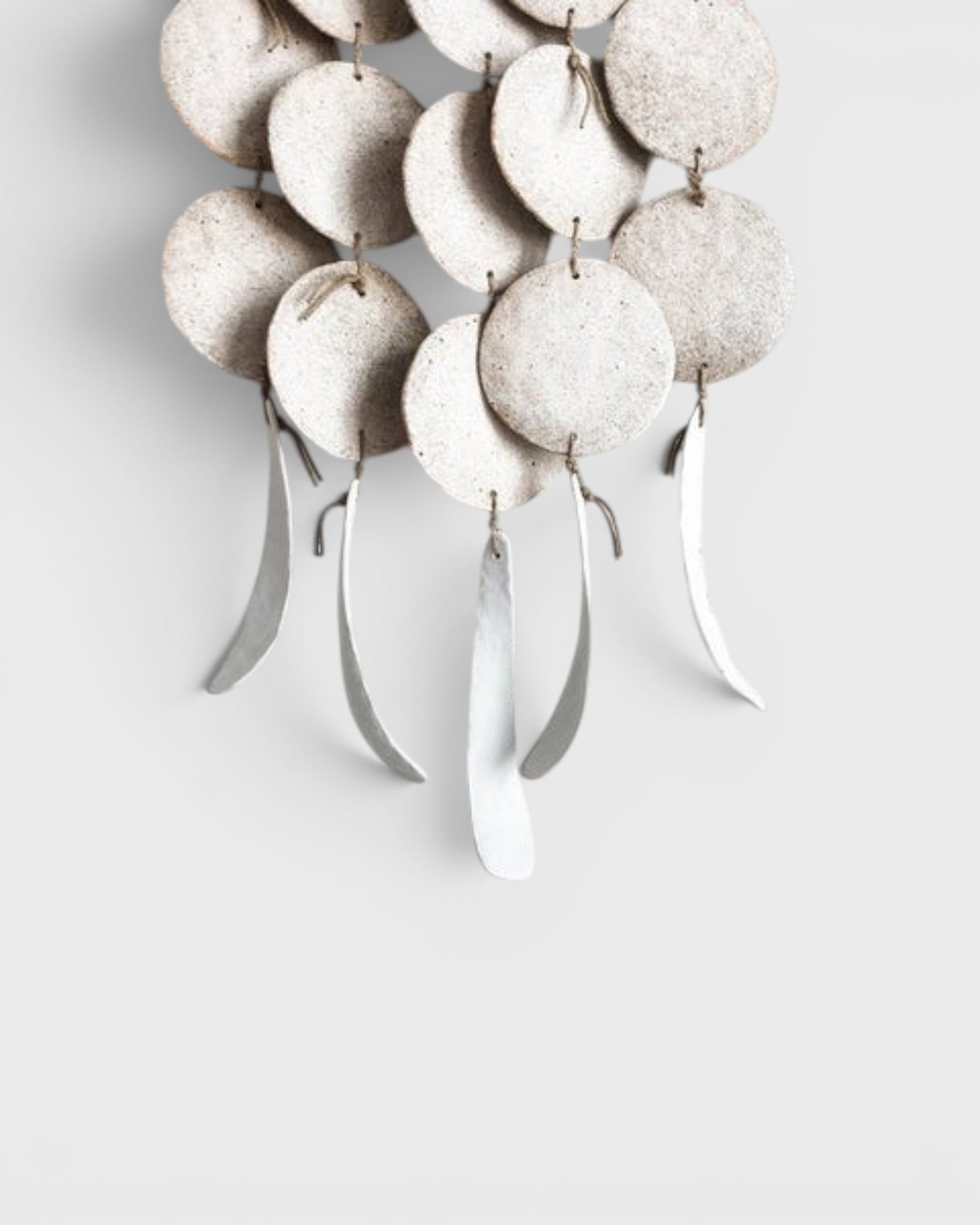 JONES + CO Dreamweaver wall hanging in Full Moon White featuring glazed stoneware discs and hemp rope accents.