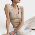 JONES + CO Dune ribbed knit tank top with deep scoop neckline on a model.