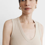 JONES + CO Dune ribbed knit tank top with deep scoop neckline on a woman with short brown hair.