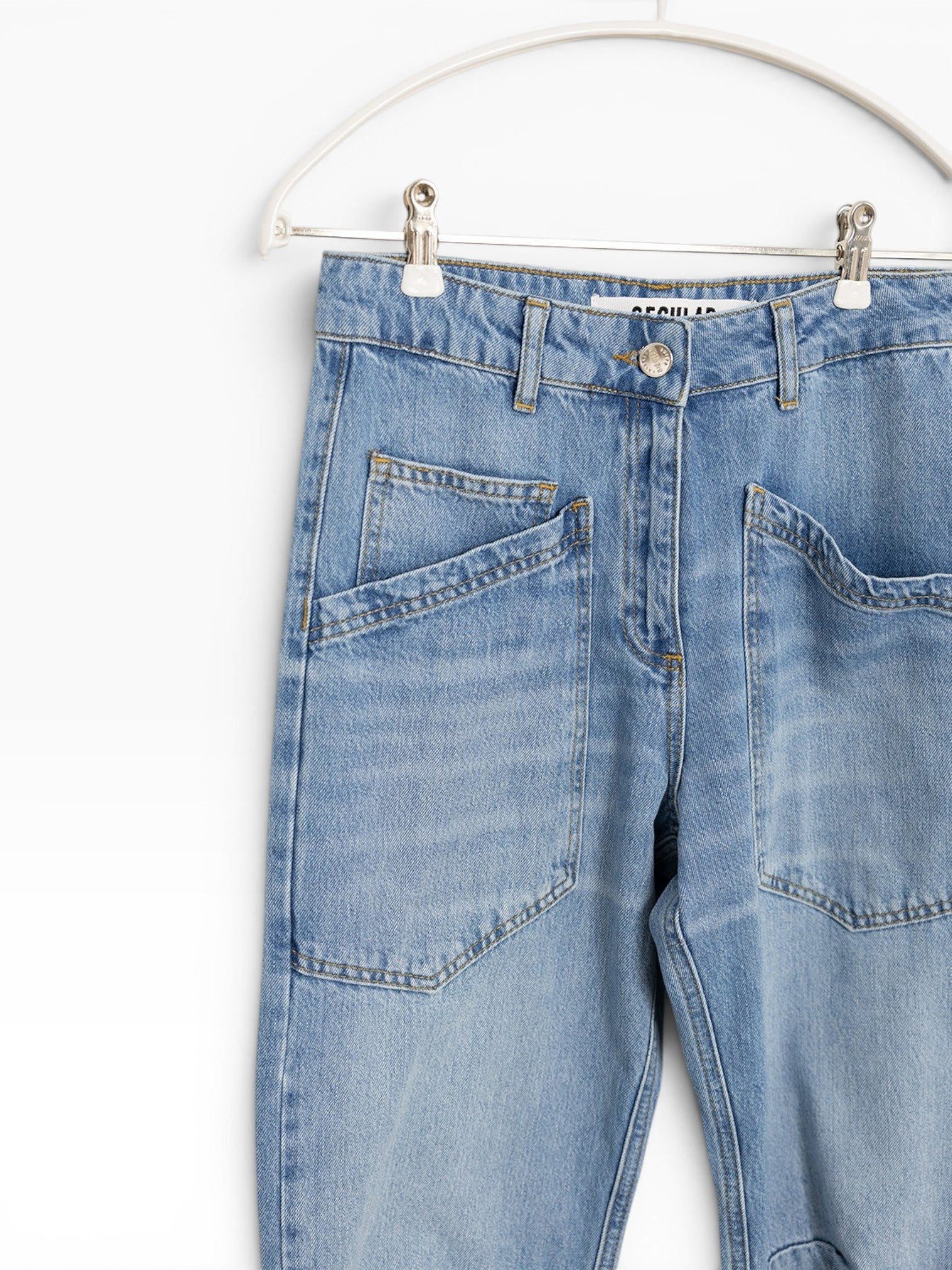 JONES + CO Easton Jean in malibu wash denim. Features a regular fit with unique angled front pockets and classic button fly.