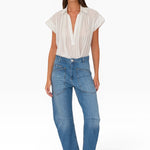 JONES + CO Easton Jean in Malibu Wash. Model wears blue denim jeans with large front pockets and a relaxed fit.