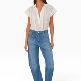 JONES + CO Easton Jean in Malibu Wash. Model wears blue denim jeans with large front pockets and a relaxed fit.
