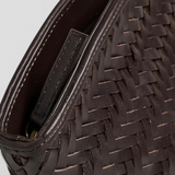 JONES + CO Elin Pouch in espresso brown braided calfskin leather with a zip closure and woven texture.