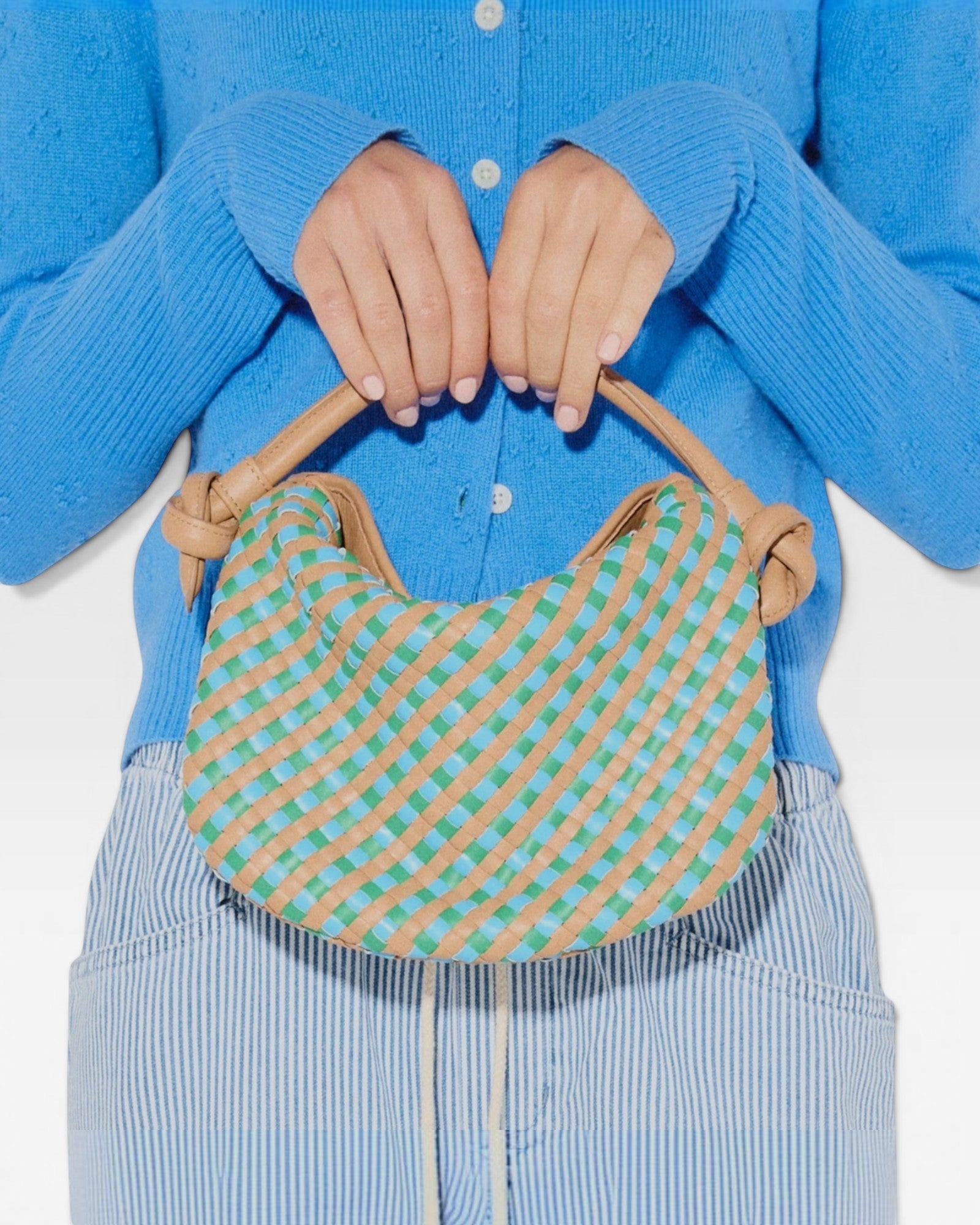 JONES + CO Elis Mini Crescent Bag in woven cognac calf leather with blue and green checkered pattern. Features knotted straps.