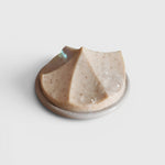 JONES + CO Erode Linden soap with chamomile and calendula on a round white ceramic dish