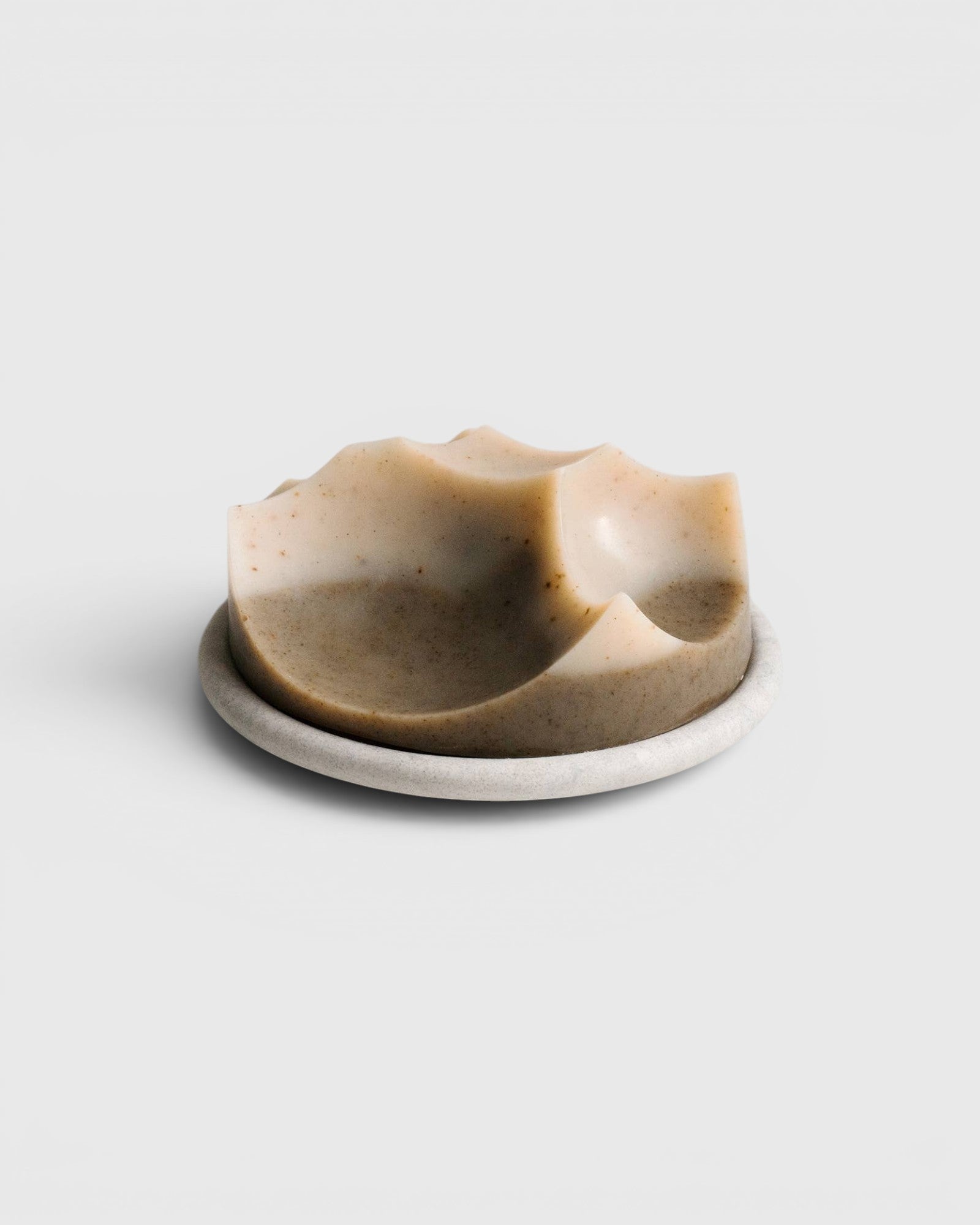 JONES + CO Erode soap in Cardamom Vetiver scent, featuring a unique sculpted shape on a matching Bouton plate.
