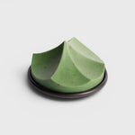 JONES + CO Erode Soap in Herbes de Provence, a green botanical bar with a unique sculpted mountain shape on a plate.