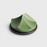 JONES + CO Erode Soap in Herbes de Provence, a green botanical bar with a unique sculpted mountain shape on a plate.