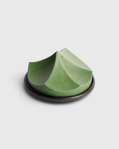 JONES + CO Erode Soap in Herbes de Provence, a green botanical bar with a unique sculpted mountain shape on a plate.