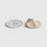 JONES + CO Erode Linden soap with botanical flecks next to a grey marbled Bouton soap dish on a white background.
