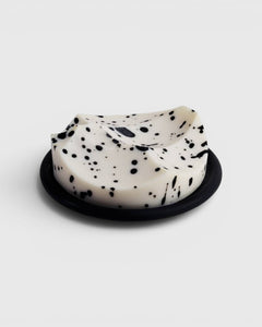 JONES + CO UME Studio Erode Soap in white with black speckles, featuring a sculptural shape on a black base.