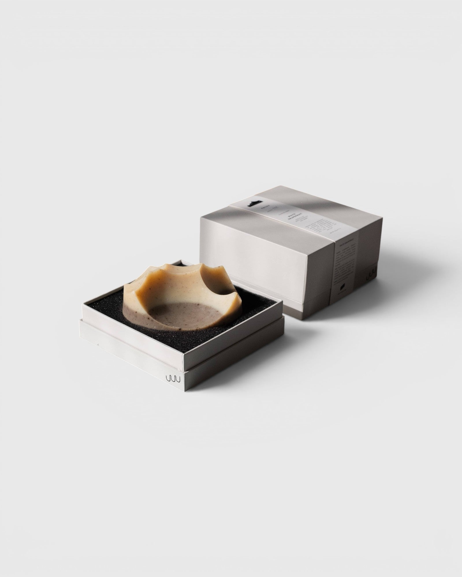 JONES + CO Erode Summit soap in Cardamom Vetiver scent, featuring a unique hand-cast shape in a minimalist gift box.