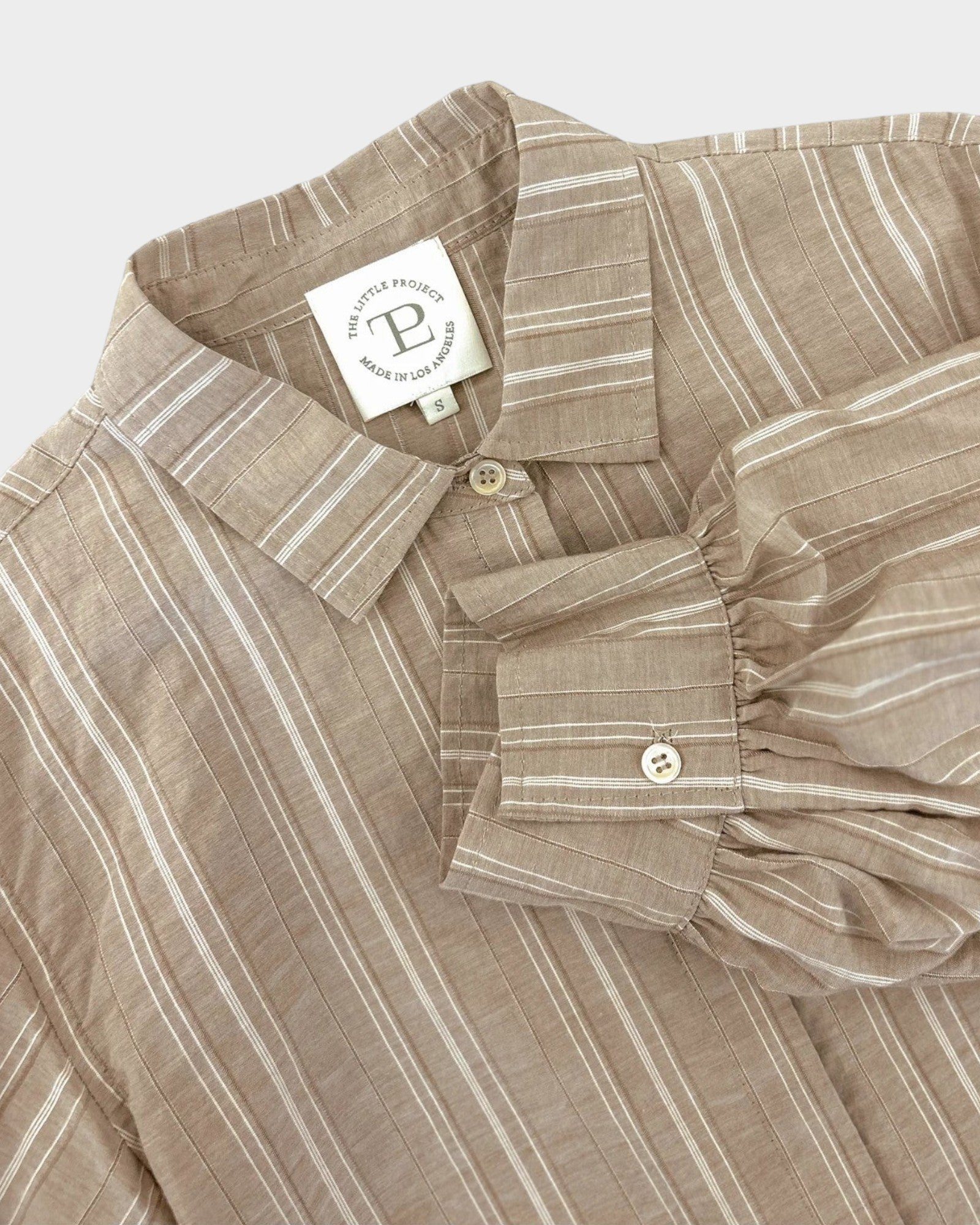 JONES + CO Esme Blouse in biscuit striped cotton poplin. Features lined puff sleeves, pearl buttons, and a covered placket.