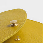 JONES + CO Faba Fanny Bag in chartreuse leather with brass hardware and stitching detail.