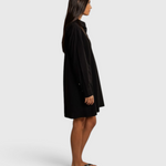 JONES + CO Felicia black poplin shirt dress in a relaxed cotton silhouette worn by a model against a draped backdrop