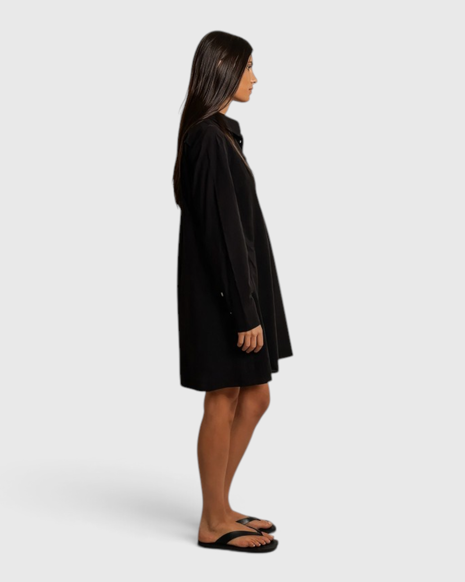 JONES + CO Felicia black poplin shirt dress in a relaxed cotton silhouette worn by a model against a draped backdrop