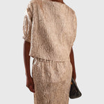 JONES + CO Filly Top in champagne shimmery textured silk with boat neckline and puff sleeves on a model