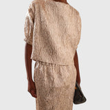 JONES + CO Filly Top in champagne shimmery textured silk with boat neckline and puff sleeves on a model