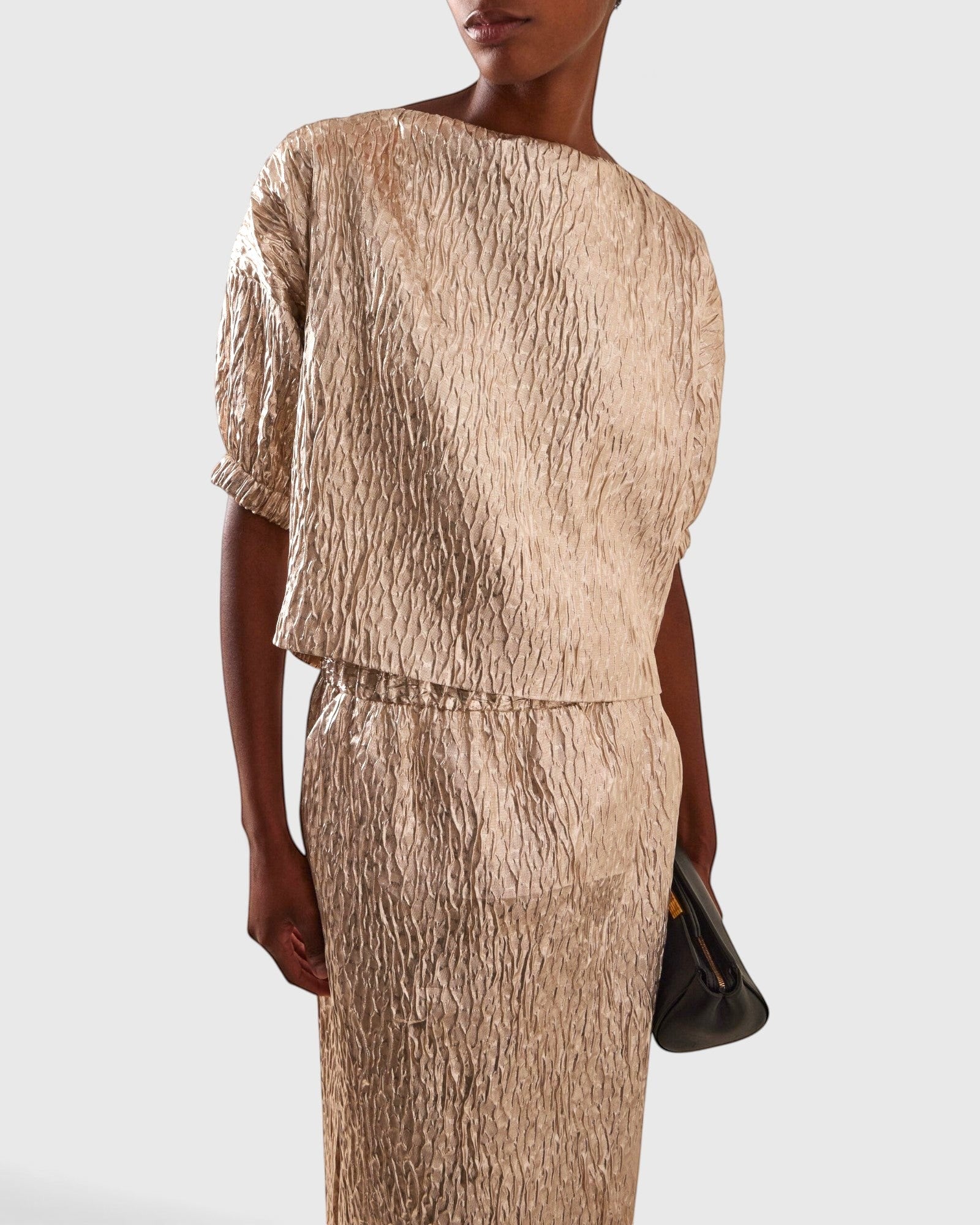 JONES + CO Filly Top in champagne shimmery textured silk with boat neckline and puff sleeves on a model