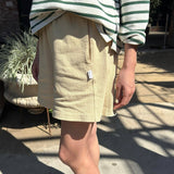 JONES + CO butter yellow 100% cotton flared basketball shorts with a raw textured yet soft and airy feel.