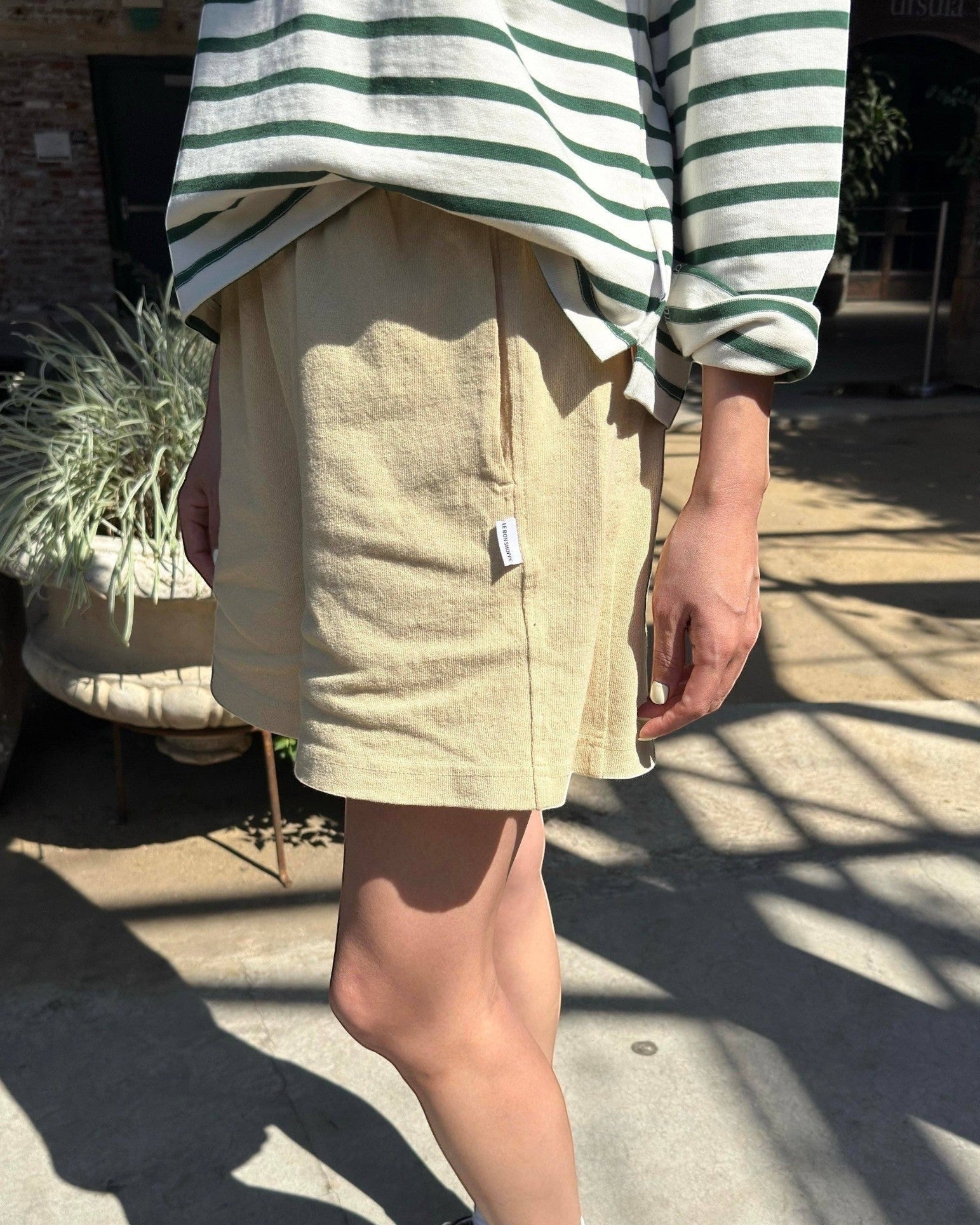 JONES + CO butter yellow 100% cotton flared basketball shorts with a raw textured yet soft and airy feel.
