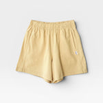 JONES + CO butter yellow 100% cotton heavyweight knit flared basketball shorts with raw texture.
