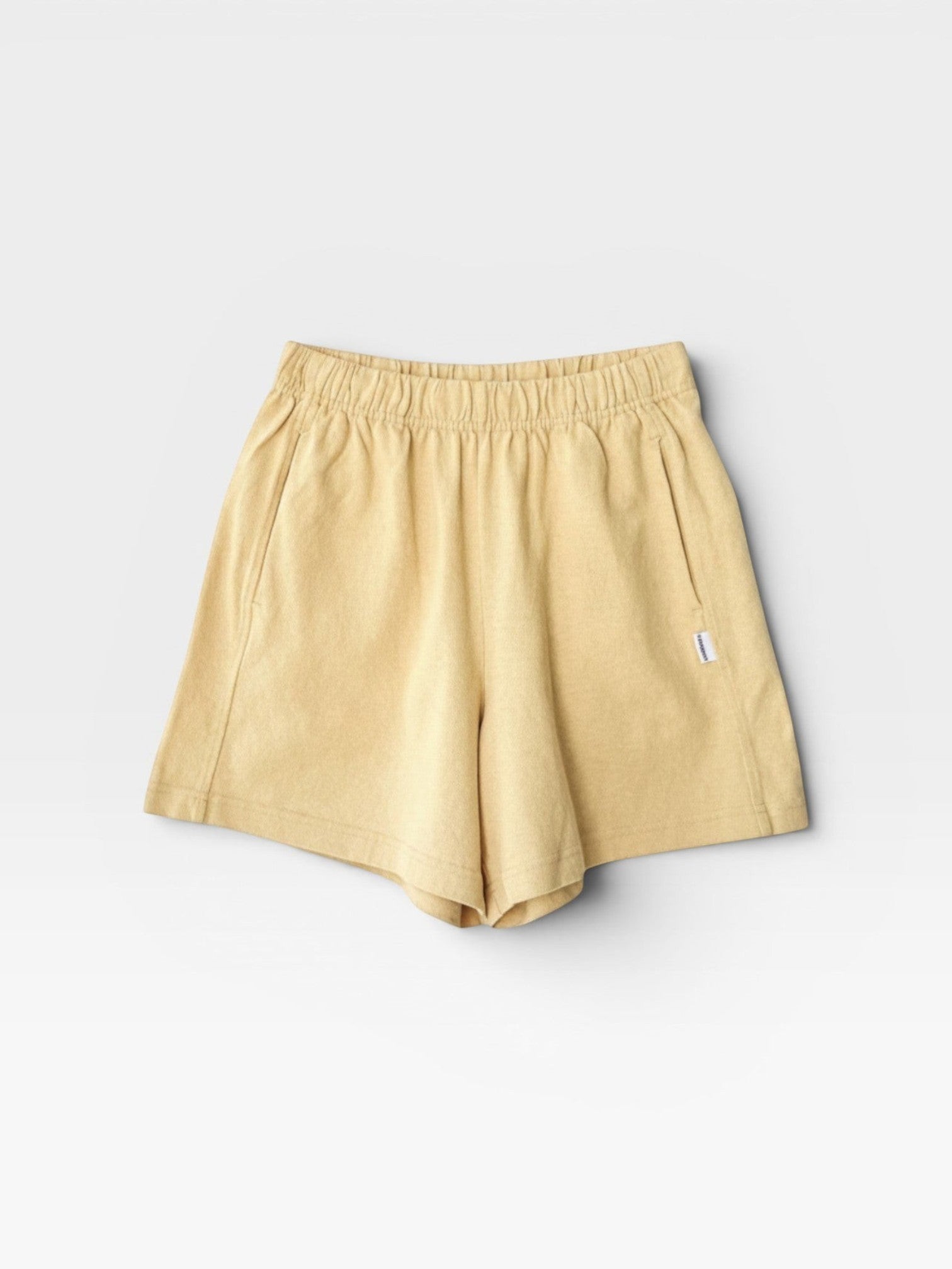 JONES + CO butter yellow 100% cotton heavyweight knit flared basketball shorts with raw texture.