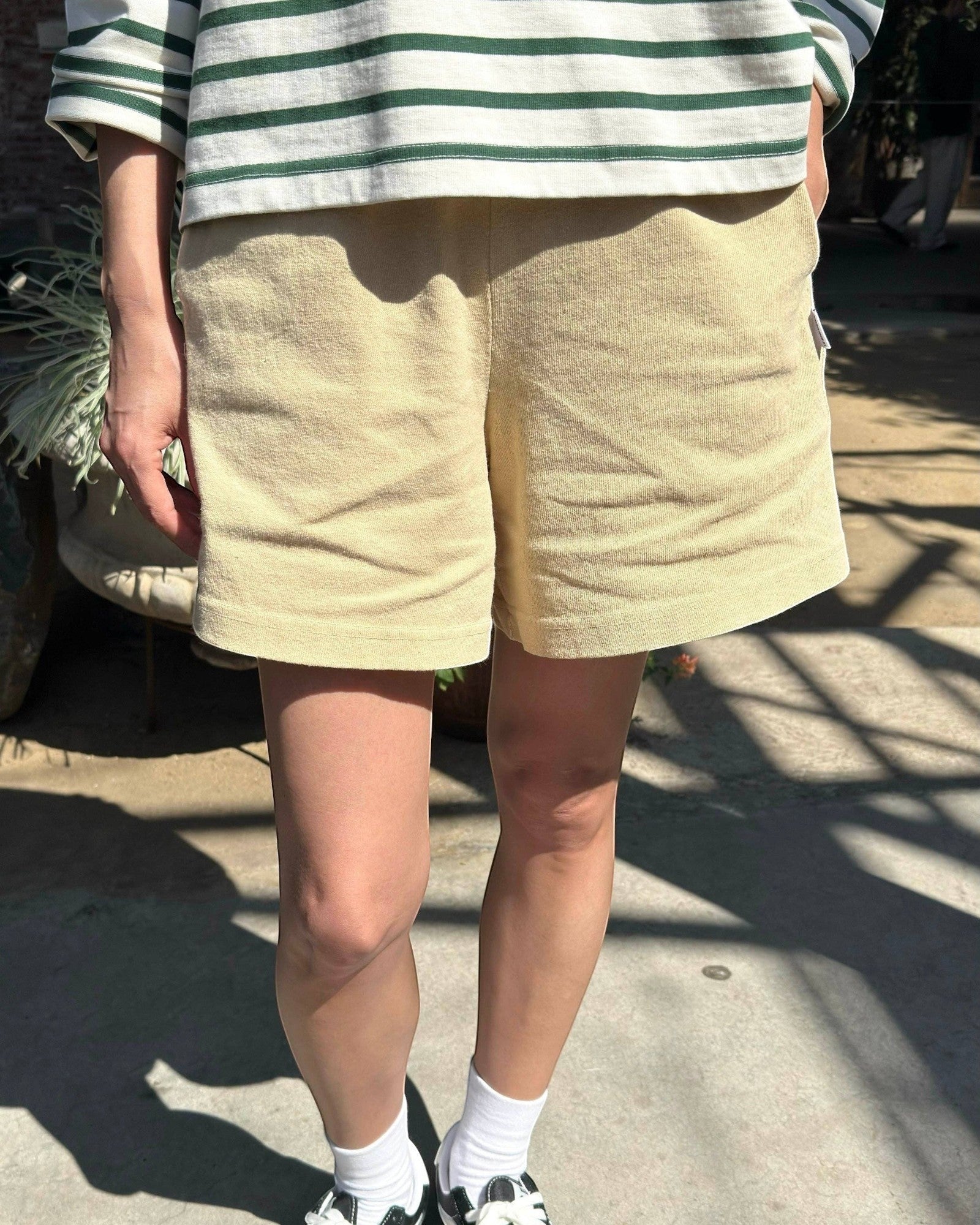 JONES + CO butter yellow 100% cotton flared basketball shorts with a textured knit and mid-thigh length.