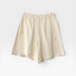 JONES + CO natural cotton knit flared basketball shorts with elastic waist and pockets.