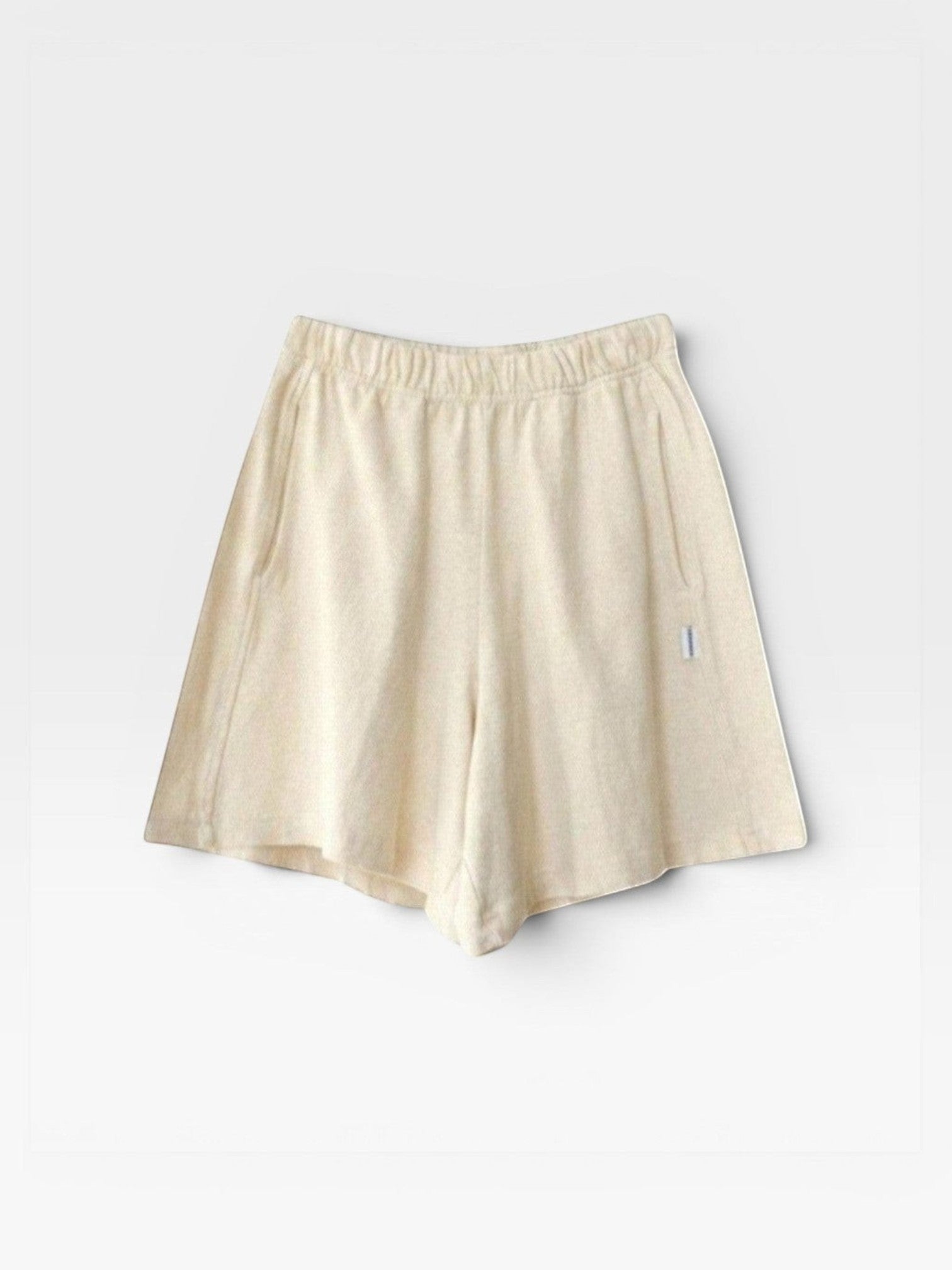 JONES + CO natural cotton knit flared basketball shorts with elastic waist and pockets.