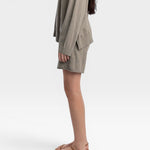 JONES + CO fog green relaxed mid-length knit shorts with elastic waistband and drawstring.