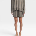 JONES + CO relaxed mid-length knit shorts in fog green with elastic waistband and drawstring. Fully fashioned.