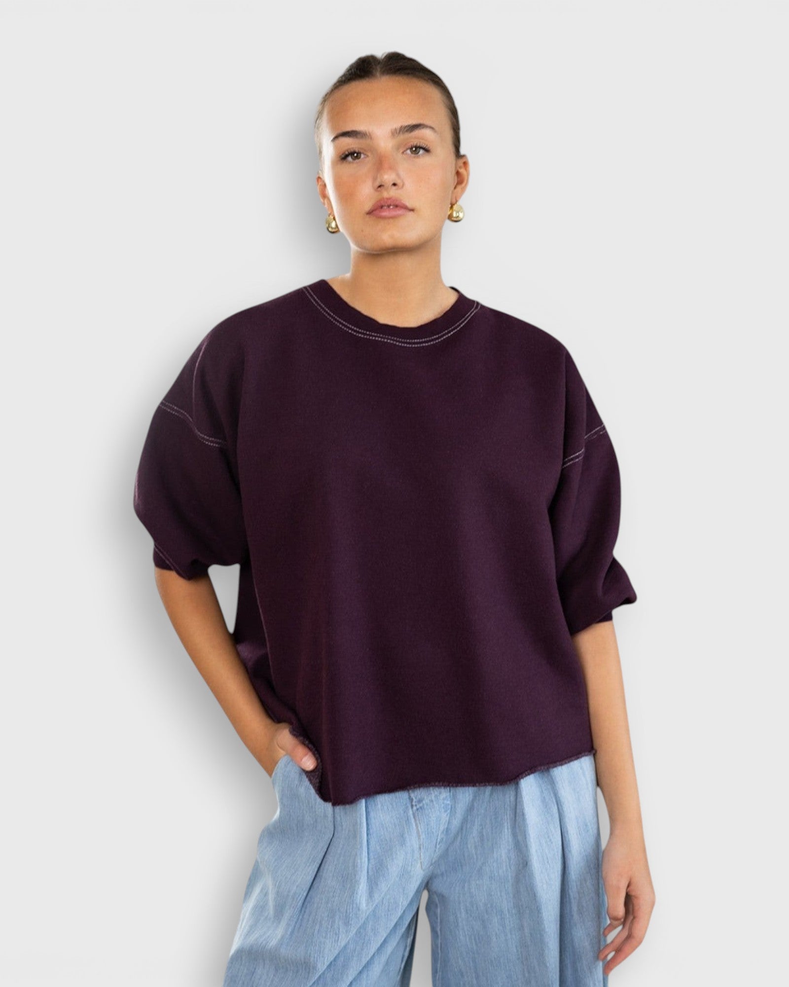 JONES + CO Rachel Comey Fond sweatshirt in plum with drop shoulders, cropped sleeves, and raw edge hemline.