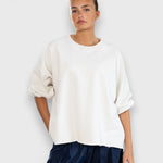 JONES + CO Rachel Comey Fond crewneck sweatshirt in dirty white with drop shoulders and raw edge hemline.