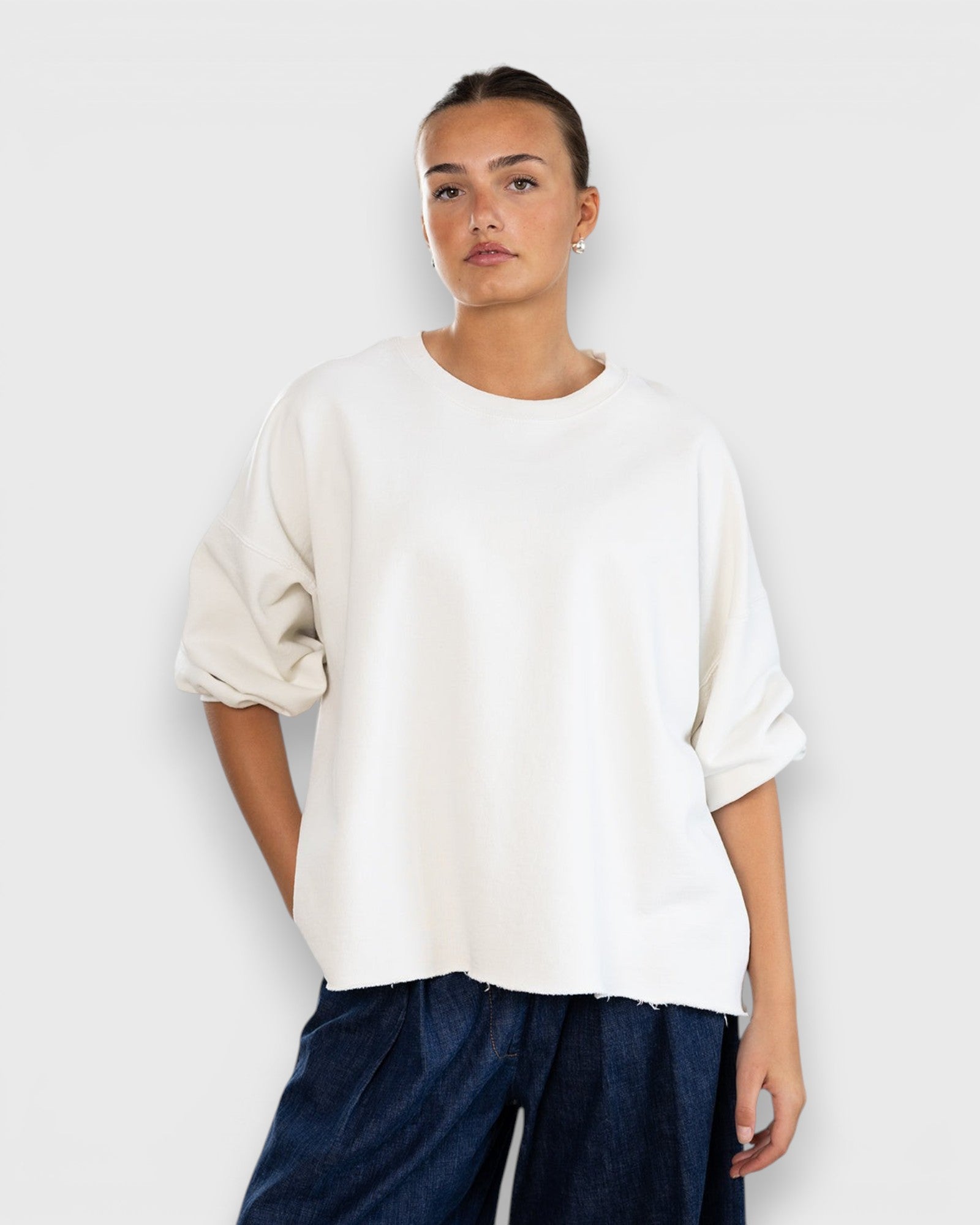 JONES + CO Rachel Comey Fond crewneck sweatshirt in dirty white with drop shoulders and raw edge hemline.
