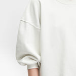 JONES + CO Rachel Comey Fond crewneck sweatshirt in dirty white with drop shoulders and raw edge hemline