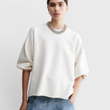 JONES + CO Rachel Comey Fond crewneck sweatshirt in dirty white with drop shoulders and raw edge hem on a model