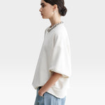 JONES + CO Rachel Comey Fond sweatshirt in dirty white with drop shoulders, cropped sleeves, and raw edge hemline.